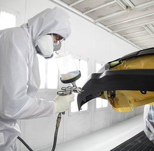 Collision Center Technician Painting a Vehicle | Toyota of Madison in Madison IN